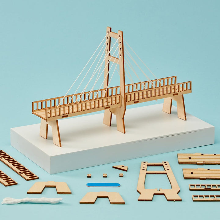 Kitsville ST022: Cable-stayed bridge model and parts on blue background