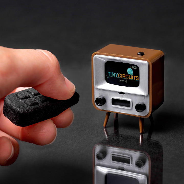 Brown TinyCircuits TinyTV 2 with handheld infrared remote