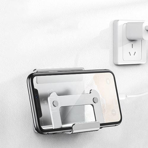 Silver wall holder with phones beside a separate charger