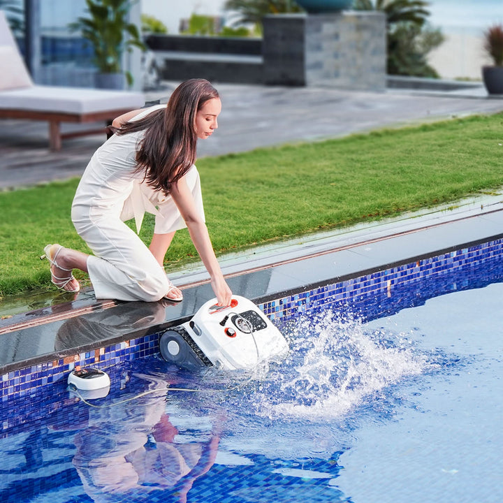 Sublue BN Pro robotic pool cleaner being lowered into a swimming pool