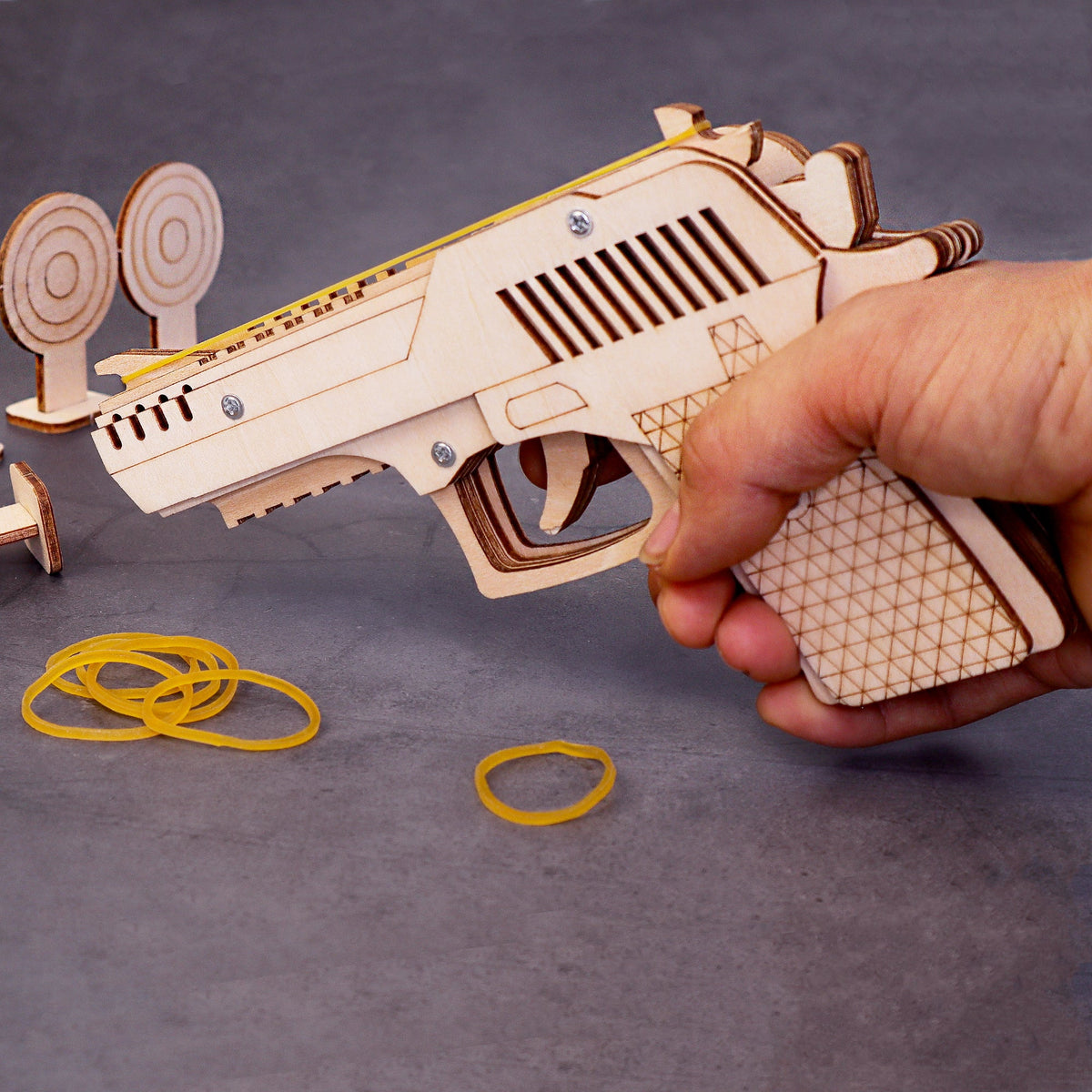 Kitsville Rubber Band Launcher Building Kit — hand holding assembled model