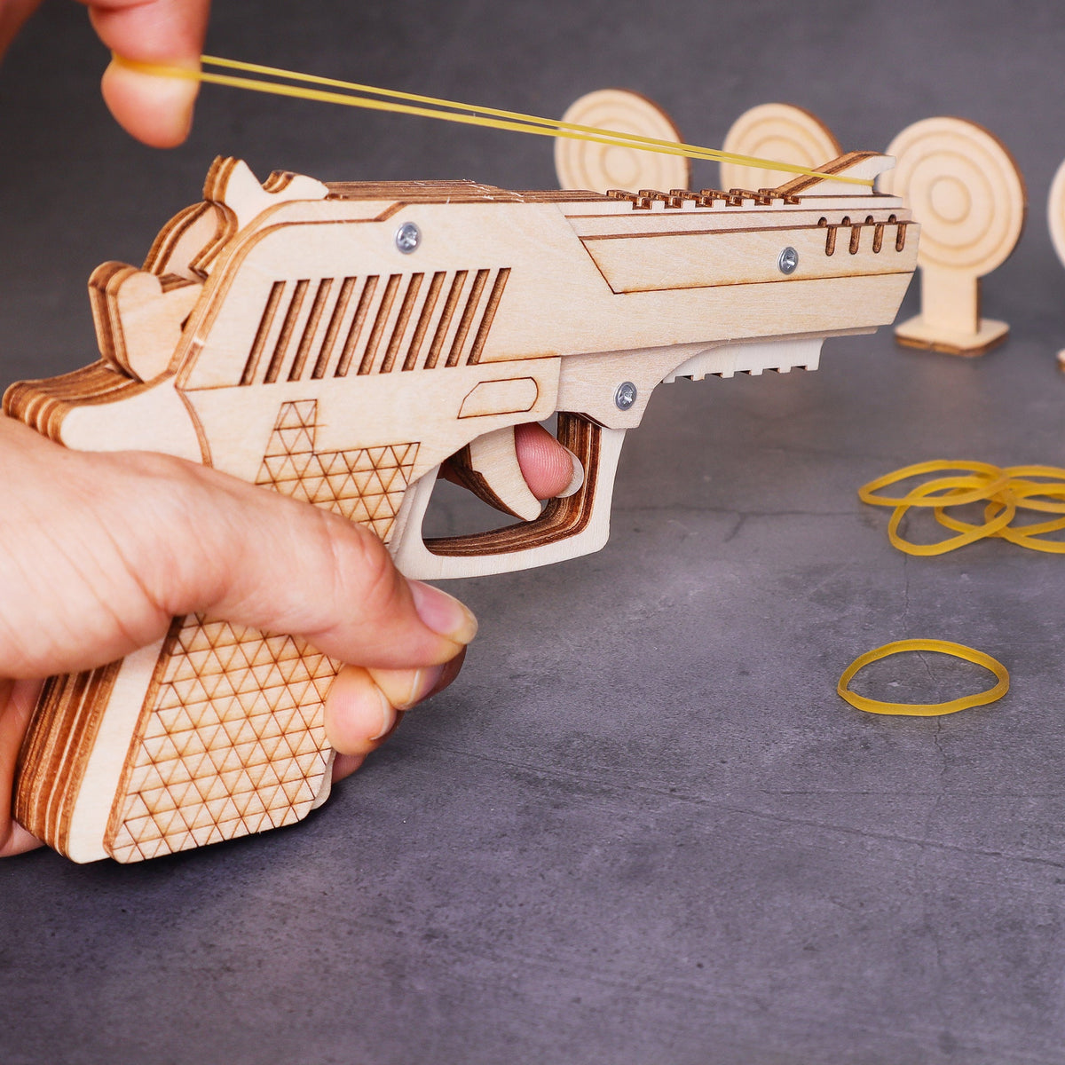 Kitsville Rubber Band Launcher Building Kit — loading a rubber band