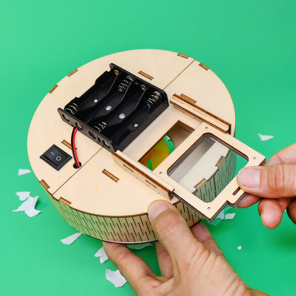 Kitsville Mini Robot Vacuum STEM Kit — hand removing collection bin