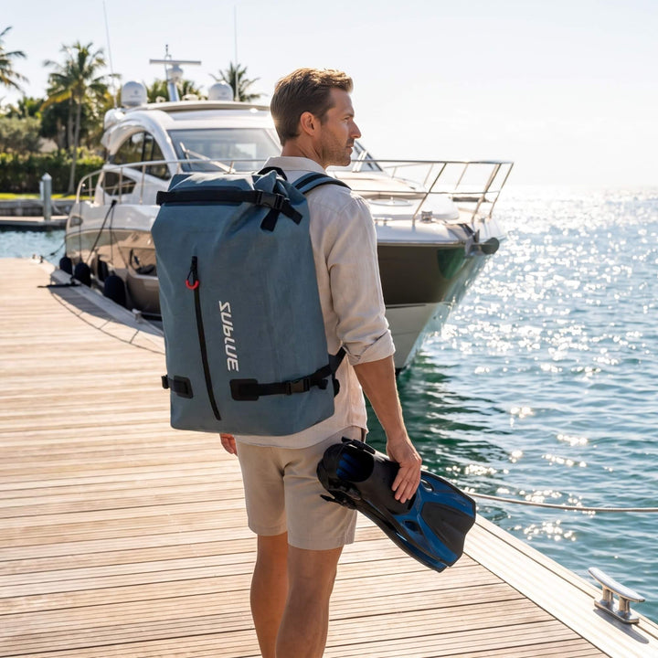 Person carrying a Sublue 52L waterproof backpack beside a boat