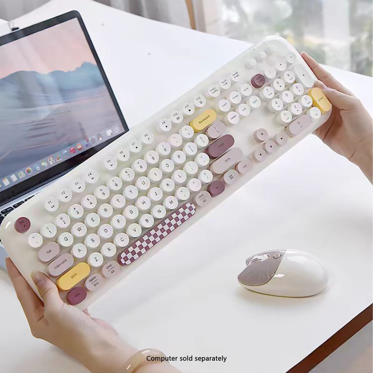 Beige KB8 keyboard held above a desk beside its mouse