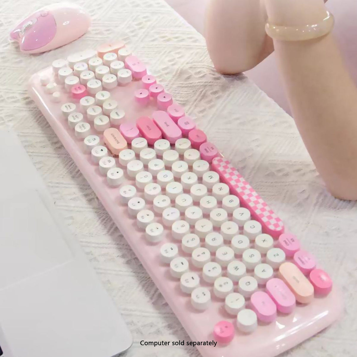 Pink KB10 keyboard shown on a desk with decorative accessories