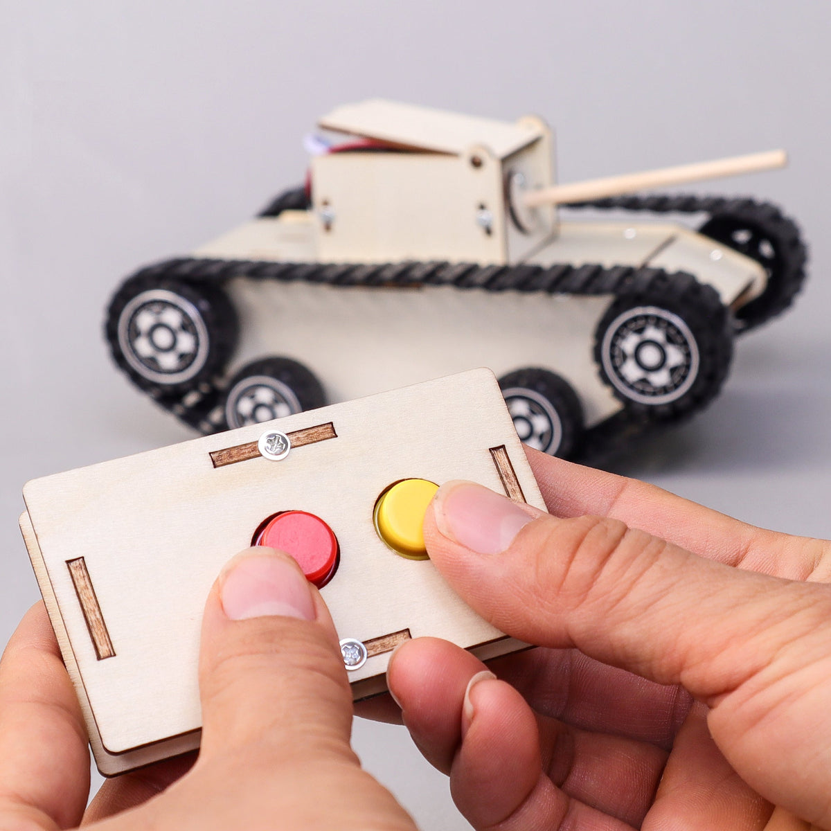 Kitsville Remote-Controlled Tank Building Kit — hands using controller