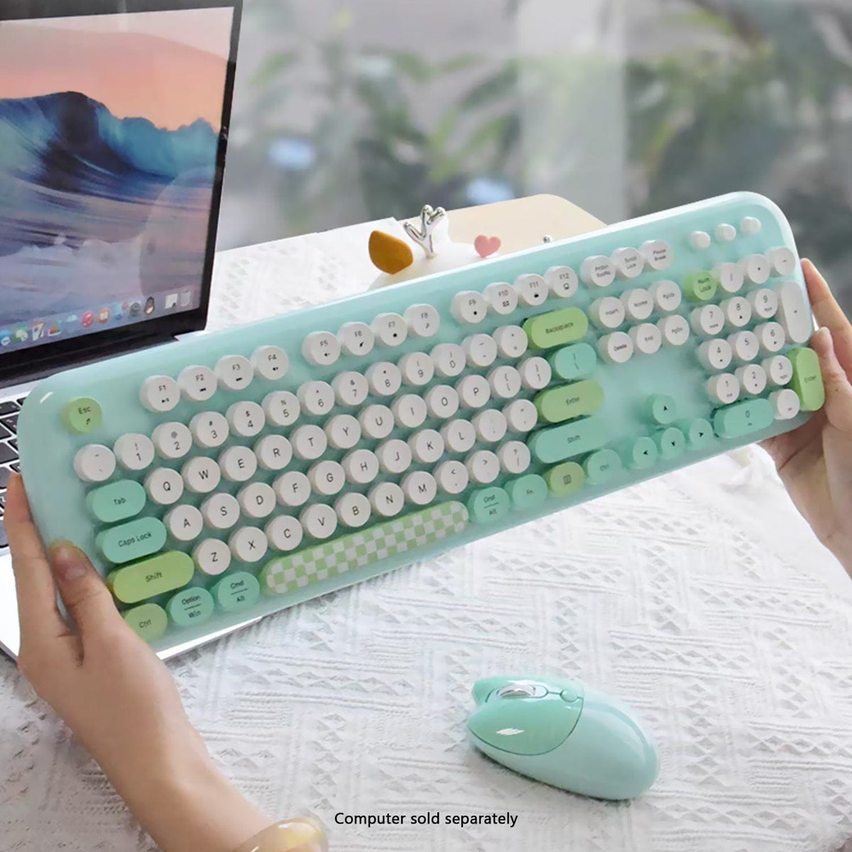 Green KB9 keyboard held above a desk