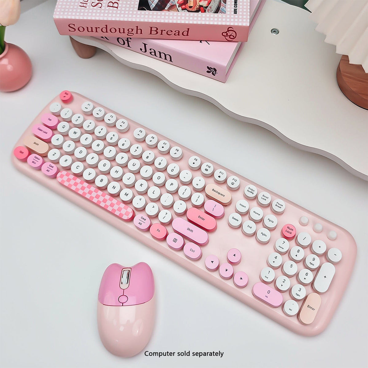 Pink KB10 keyboard and mouse viewed diagonally on a desk