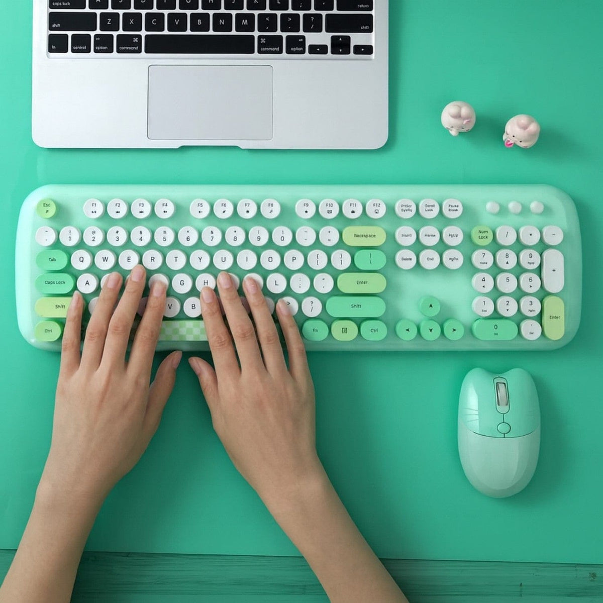 Green KB9 keyboard being used beside a laptop