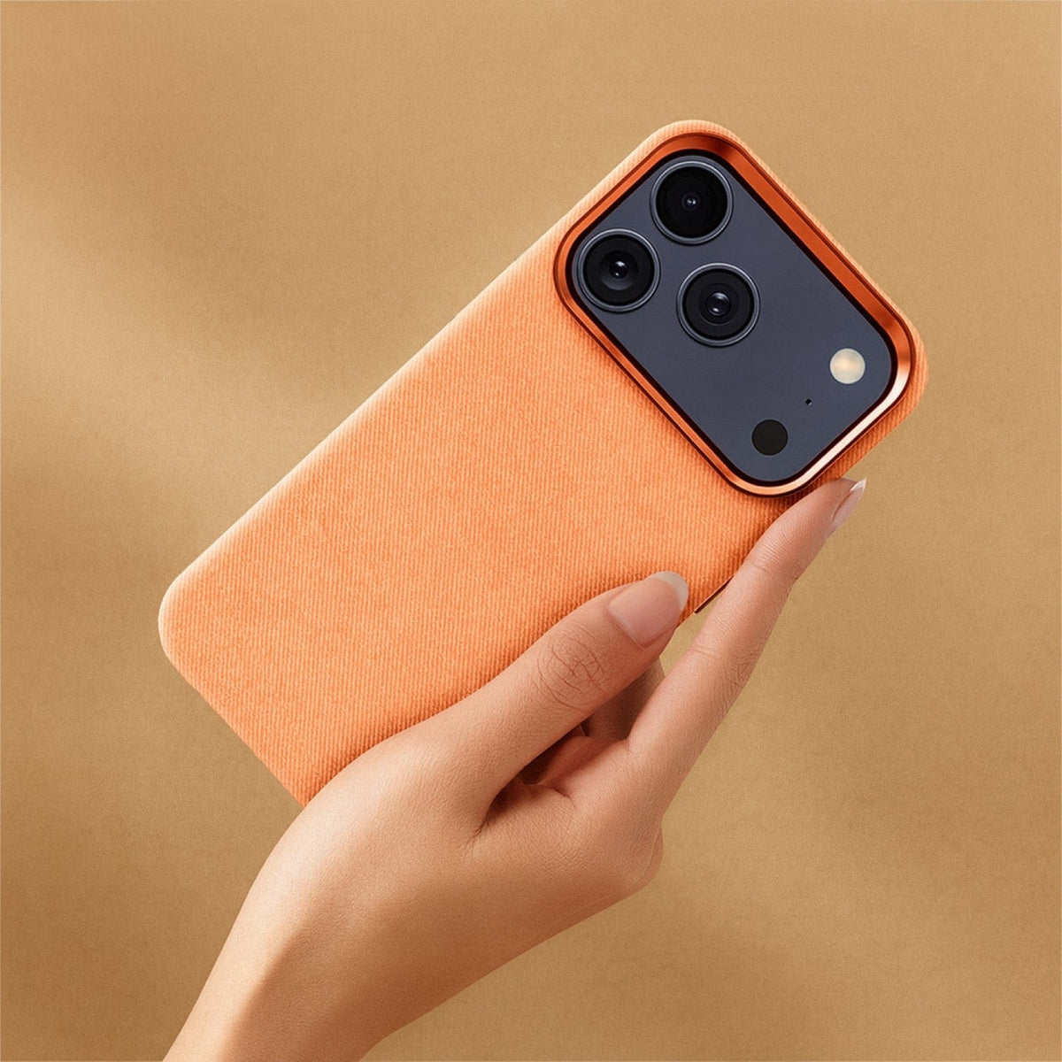 SaharaCase Indy Suede Leather Case for iPhone 17 Pro Max — orange case held in hand