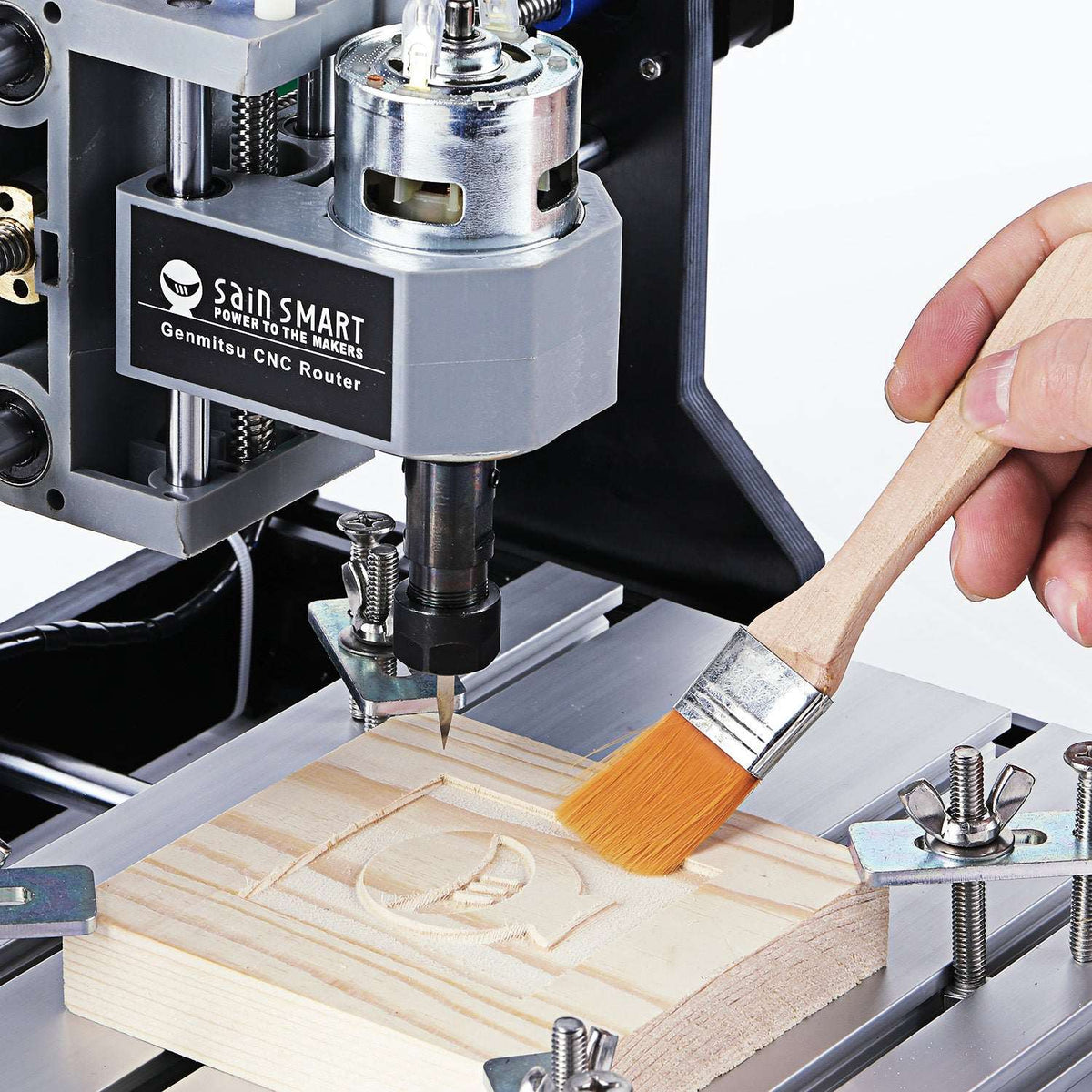 Genmitsu 3018-PRO spindle engraving wood while debris is brushed away