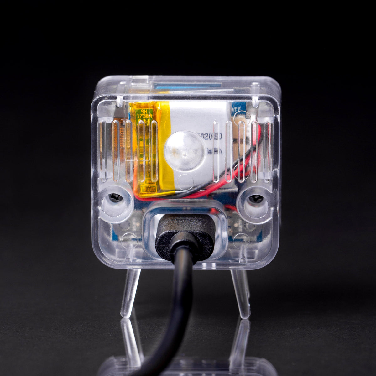 Clear TinyTV 2 rear view with USB-C cable connected; cable sold separately