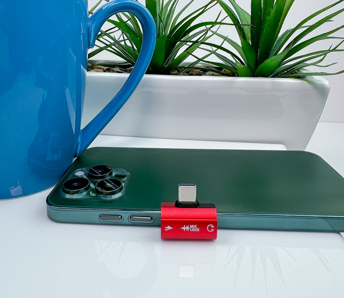 Mic-Lock Red HiFi adapter beside a phone