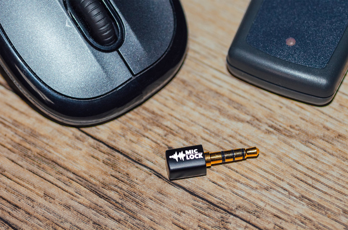 Mic-Lock Black Mini blocker beside mouse and keys