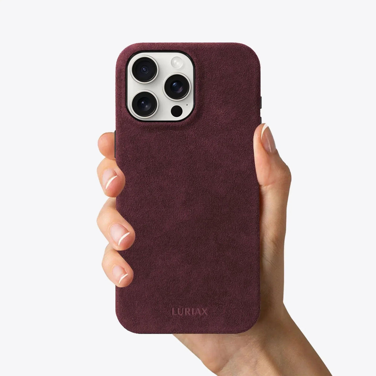 Luriax Signature Handcrafted Case iPhone 16 — Bordeaux — shown held in a hand