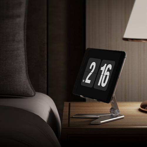 Tablet displayed on a SaharaCase stand beside a bed