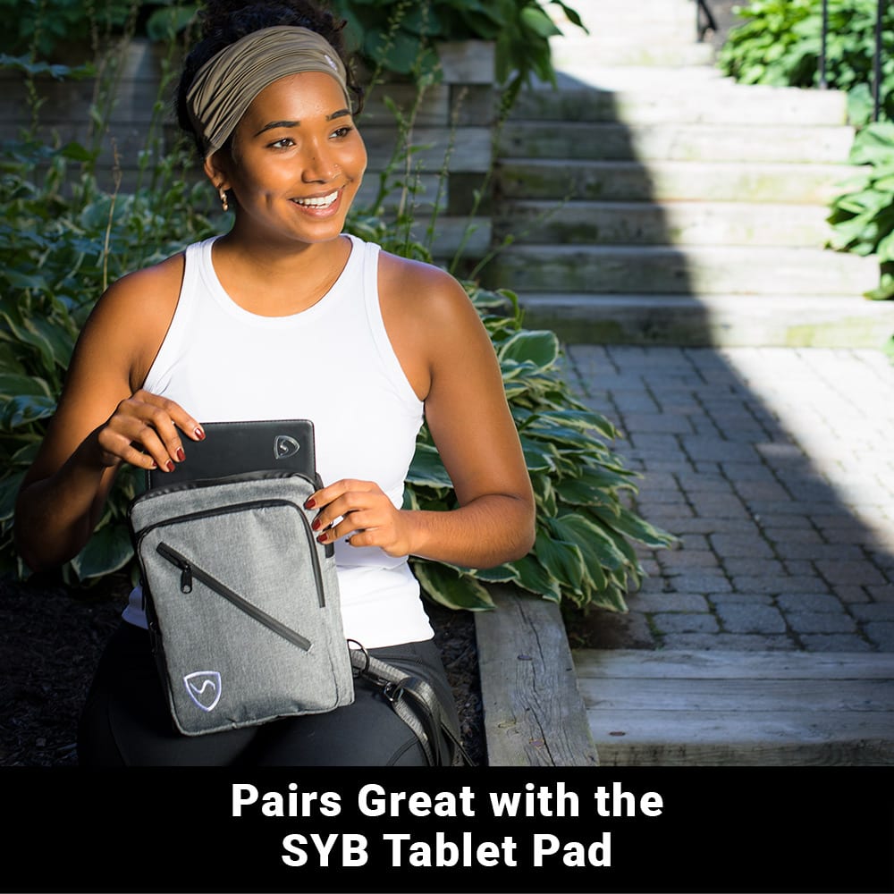 Person placing a Tablet Pad in SYB Sling Bag