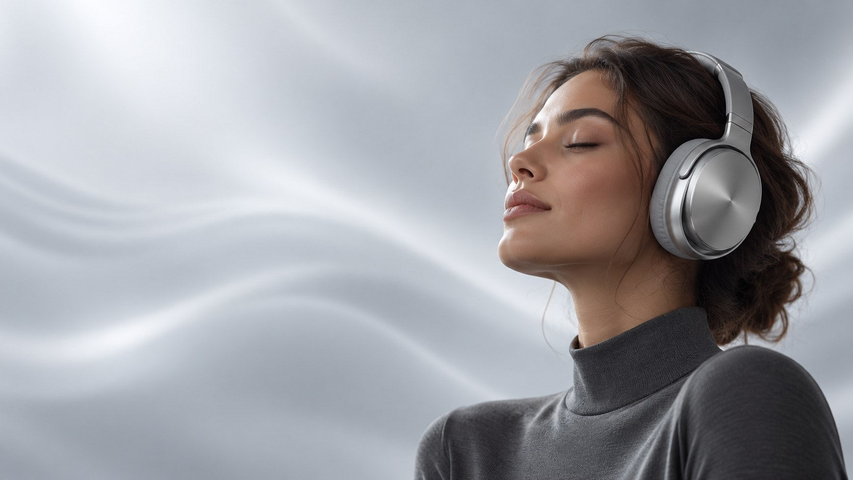 Woman wearing silver headphones in a softly lit studio